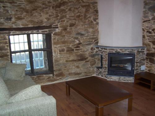 a living room with a couch and a fireplace at Alojamiento Luz de Hadas in Sampil
