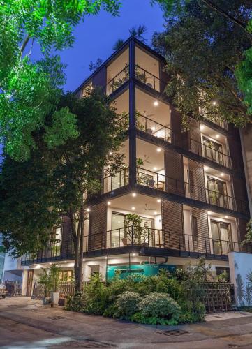 an apartment building with a lit up facade at Bungalow 99 in New Delhi
