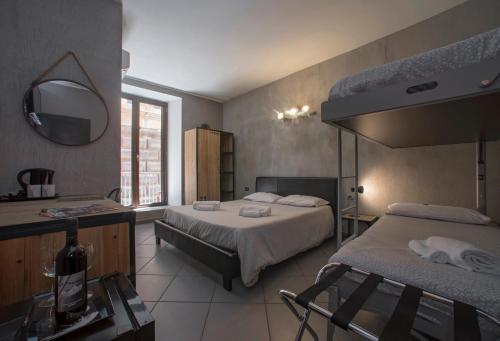 a hotel room with two beds and a mirror at Il Taschino Suite in Naples