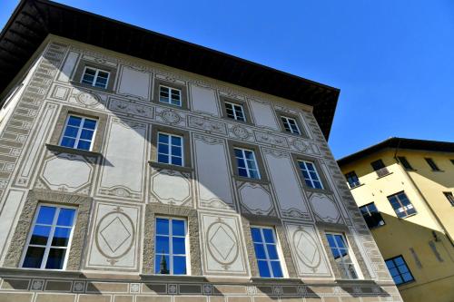 a tall building with windows on the side of it at La Croce d'Oro Santa Croce Suite Apartments in Florence