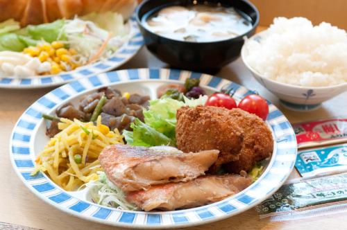 a plate of food with meat and vegetables on a table at Super Hotel Fuji Inter in Fuji