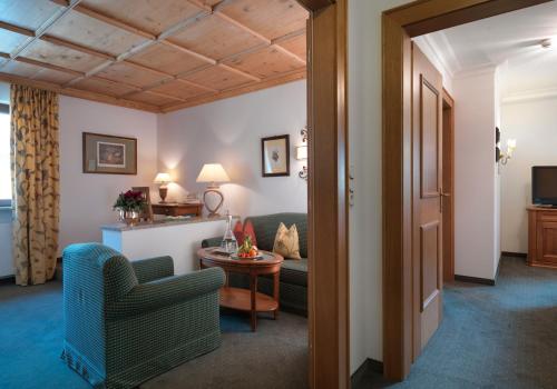 a living room with a couch and a table at Hotel Zürserhof in Zürs am Arlberg
