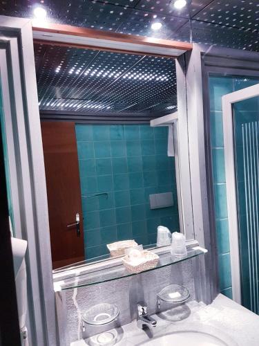 a bathroom with a sink and a mirror at HR Hotel in Monfalcone