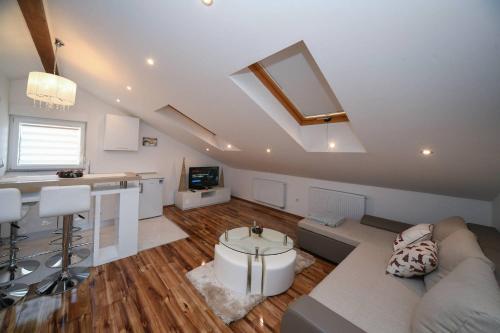 a large living room with a couch and a kitchen at "Oasis of Peace Zagreb-Apartments" in Zagreb