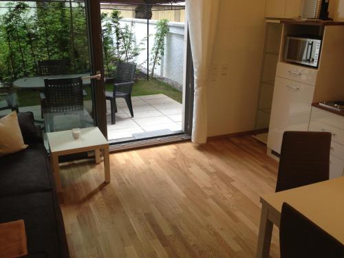 a living room with a door open to a patio at City Apartment Munich in Munich