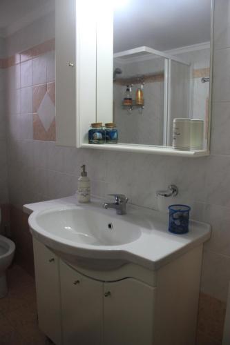 a bathroom with a sink and a mirror at Quiet spacious apartment in Nafplio in Nafplio
