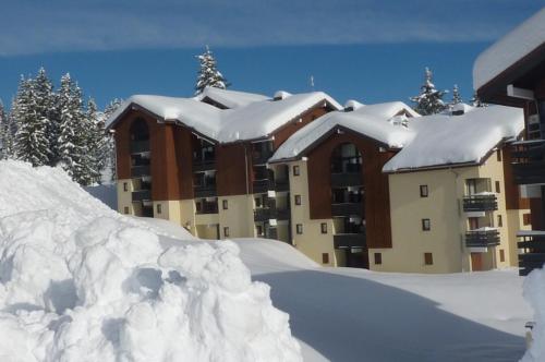 une pile de neige devant un bâtiment dans l'établissement Combe BLANCHE 1202, à Manigod