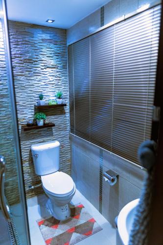 a bathroom with a toilet and a sink at ARMO Nimman in Chiang Mai