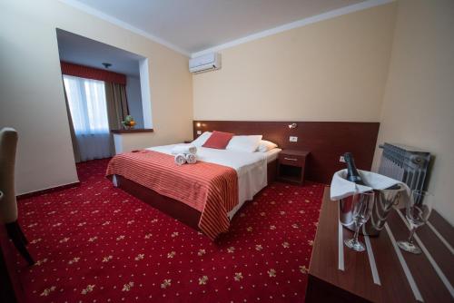 a hotel room with a bed and a red carpet at Villa Anton in Sukošan