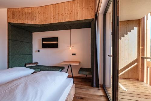 Ένα ή περισσότερα κρεβάτια σε δωμάτιο στο Oberhauser Hütte Rodenecker - Lüsner Alm