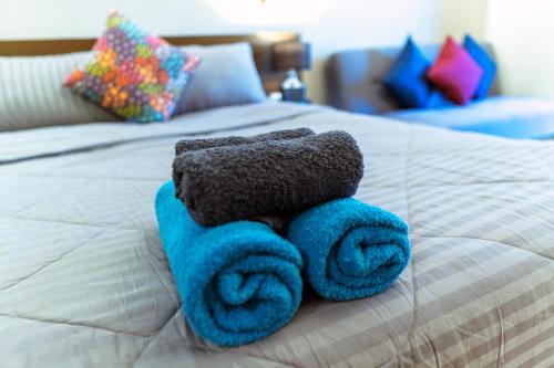 a stuffed teddy bear on a bed with towels at ARMO Nimman in Chiang Mai