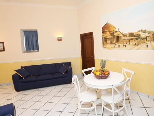 uma sala de estar com uma mesa e um sofá em Santa Lucia 50 em Nápoles