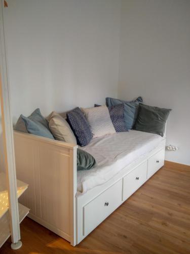 a bed with pillows on it in a room at Casa da Tia Adozinda in Lisbon