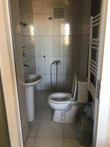 a bathroom with a toilet and a sink at Gunes Hotel in Hacıbektaş