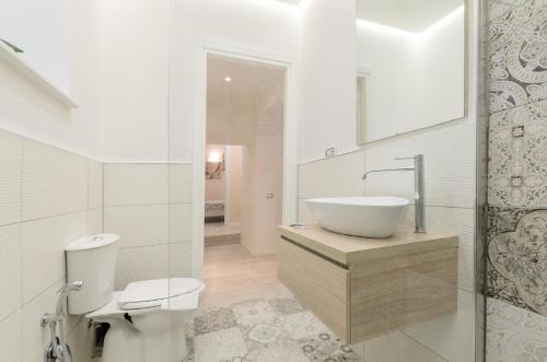 a white bathroom with a sink and a toilet at Holiday Home Taormina 2 in Taormina