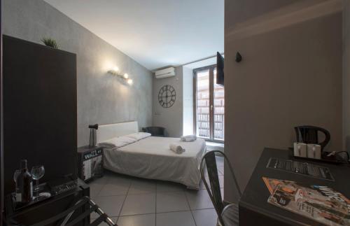 a small bedroom with a bed and a window at Il Taschino Suite in Naples
