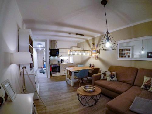 a living room with a couch and a table at Hotel Stadt Cuxhaven in Cuxhaven