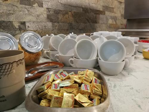 a table with a tray of crackers and cups at Albergo Ristorante Belvedere in Minucciano