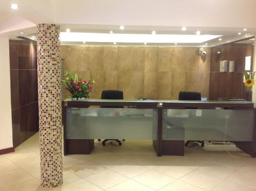 an office cubicle with a large desk and a pillar at Progressive Park Hotel in Nairobi