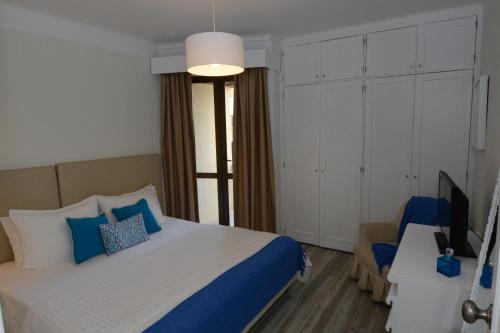 1 dormitorio con 1 cama grande y TV en Edifico Baia Apartment, en Funchal