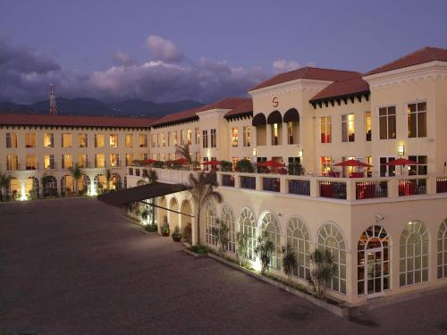 a large building with a courtyard at night at Spanish Court Hotel in Kingston