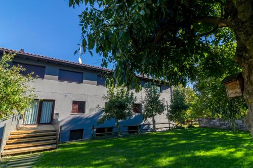 a building with a green lawn in front of it at La Pomera in Vilaller