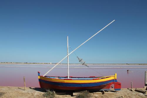 a boat sitting on the shore of a body of water at La Maison narbonnaise in Narbonne