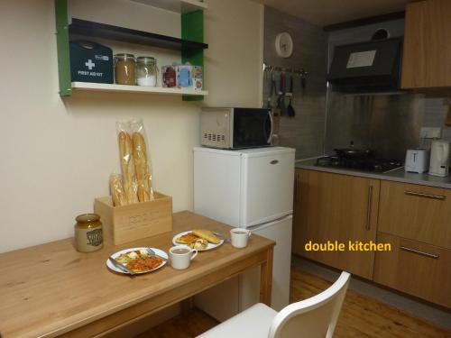 a small kitchen with a table with food on it at EdinB&B in Edinburgh