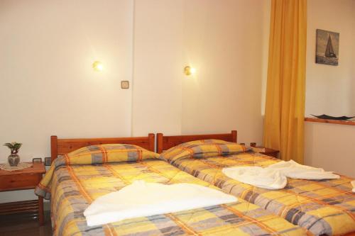 two beds sitting next to each other in a bedroom at Maria's Apartments in Kalyves