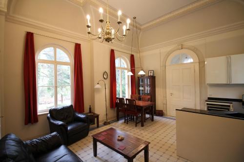 a living room with a couch and a table at Ferienwohnung Jagdschloss Bielatal in Bielatal