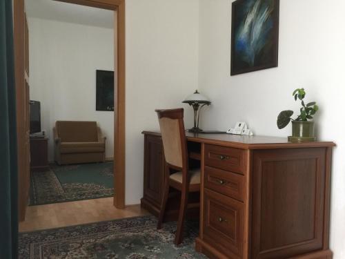 a room with a desk and a chair and a mirror at Antik Hotel Sofia in Litomyšl