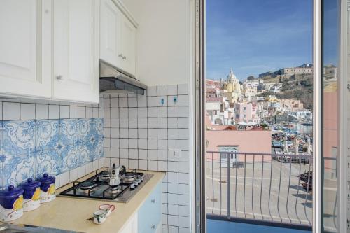 a kitchen with a view of a city at Corricella Exclusive Loft - Gioia Apartments in Procida