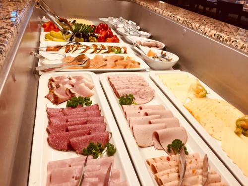 a buffet line with different meats and cheese at Hotel Obertor in Ravensburg