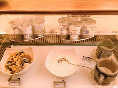 a shelf with a sink and a bowl of food at Hotel Obertor in Ravensburg