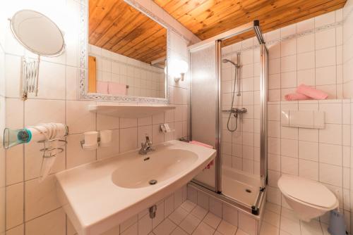 a bathroom with a sink and a shower and a toilet at Appartement Rosengarten in Obergurgl