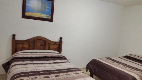 Llit o llits en una habitació de Hotel Posada Yauhtli