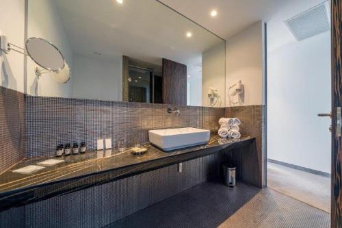 a bathroom with a sink and a mirror at Bellevue Superior City Hotel in Šibenik