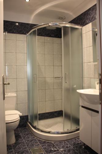 a bathroom with a shower with a toilet and a sink at Villa Thassos Paradise in Limenas