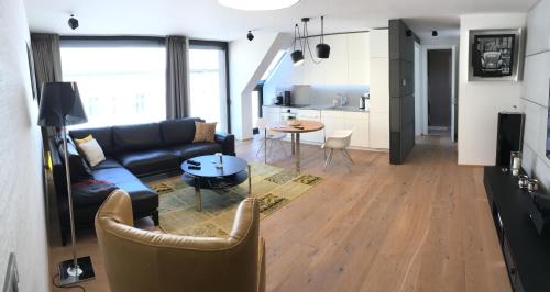 a living room with a couch and a table at Opera Suite by Zoom Apartments in Bratislava