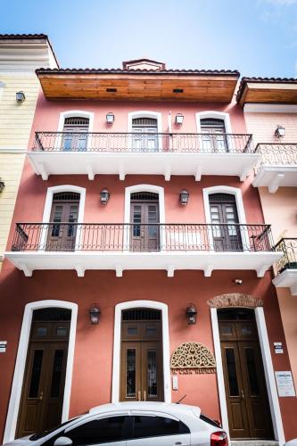 a pink building with a car parked in front of it at Small loft at Casa Neuman, Casco Antiguo in Panama City