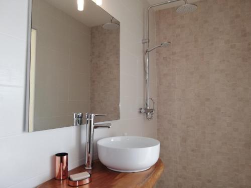 a bathroom with a white sink and a mirror at COLIBRIS PARADISE LA MARINA in Le Gosier
