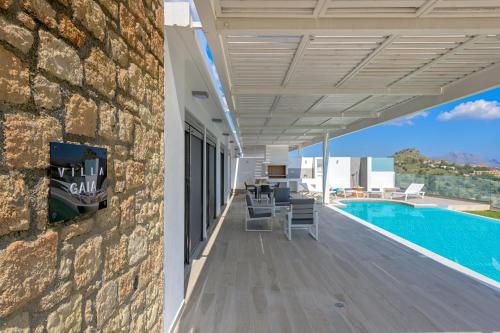 a patio of a house with a swimming pool at Villa Gaia in Lindos