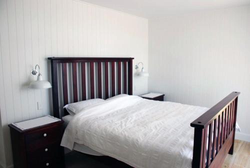 a bedroom with a large bed and two night stands at Bluebell in Forster