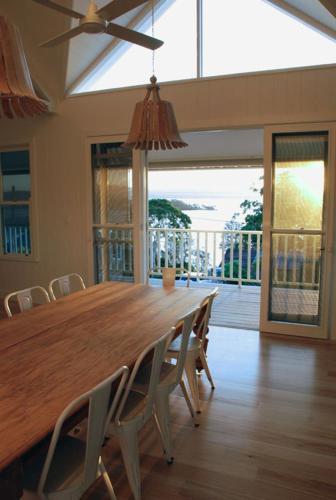 a dining room with a large wooden table and chairs at Bluebell in Forster