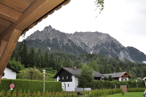 a view of a mountain with a house and trees at Haus Erli in Mittenwald