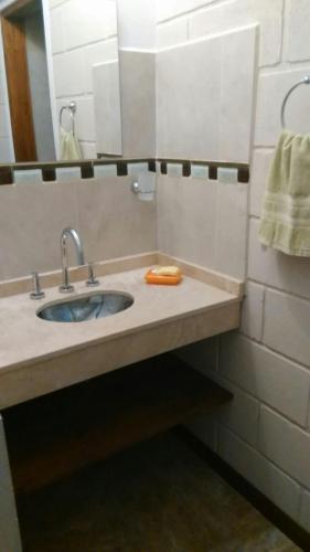 a bathroom with a sink and a mirror at Cabañas La Herradura in Villa Ciudad Parque
