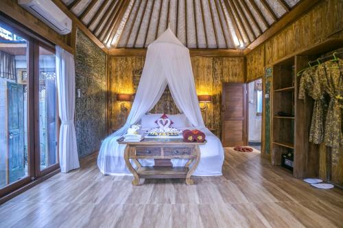 a bedroom with a bed with a canopy at The Forest Villa Ubud in Ubud
