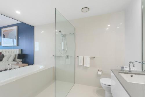 a bathroom with a tub and a toilet and a shower at Circle on Cavill - Gclr in Gold Coast