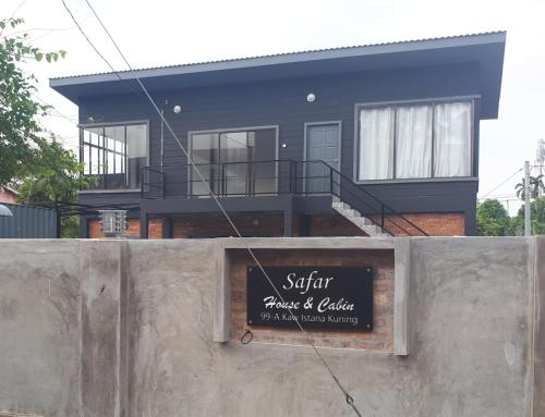 a house with a sign in front of it at Safar House & Cabin (Muslim) in Kuala Kangsar