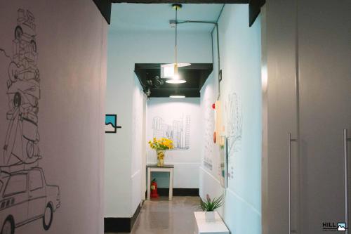 a hallway with a drawing of a car on the wall at Nampo HILL Guesthouse in Busan